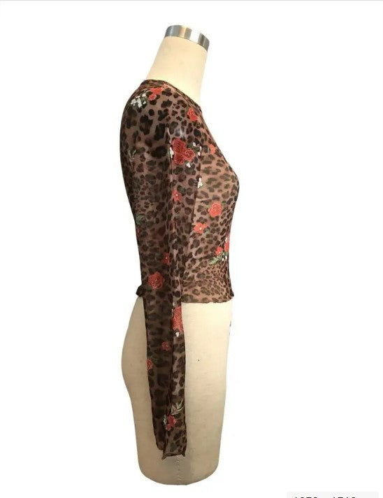 Lightweight and breathable, this mesh crop piece adds texture and edge fast — perfect for pairing with high-waisted skirts or layering under jackets.