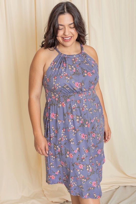 Woman wearing a floral halter neck midi dress with a flared skirt.