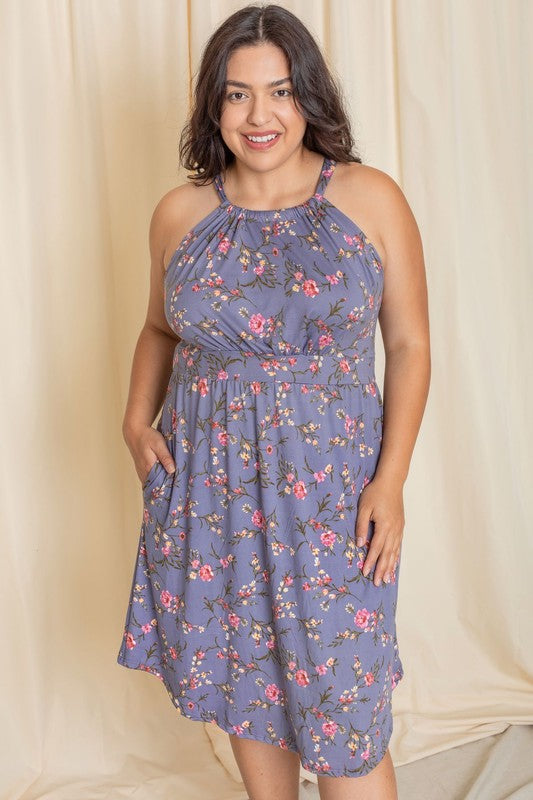 Woman wearing a floral halter neck midi dress with a flared skirt.
