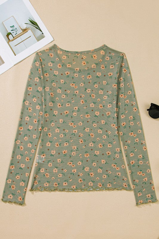 A sheer green floral top hanging beautifully.