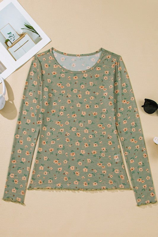 A sheer green floral top hanging beautifully.