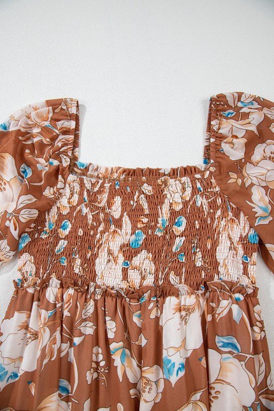 Brown floral dress with smocked bodice on a white background