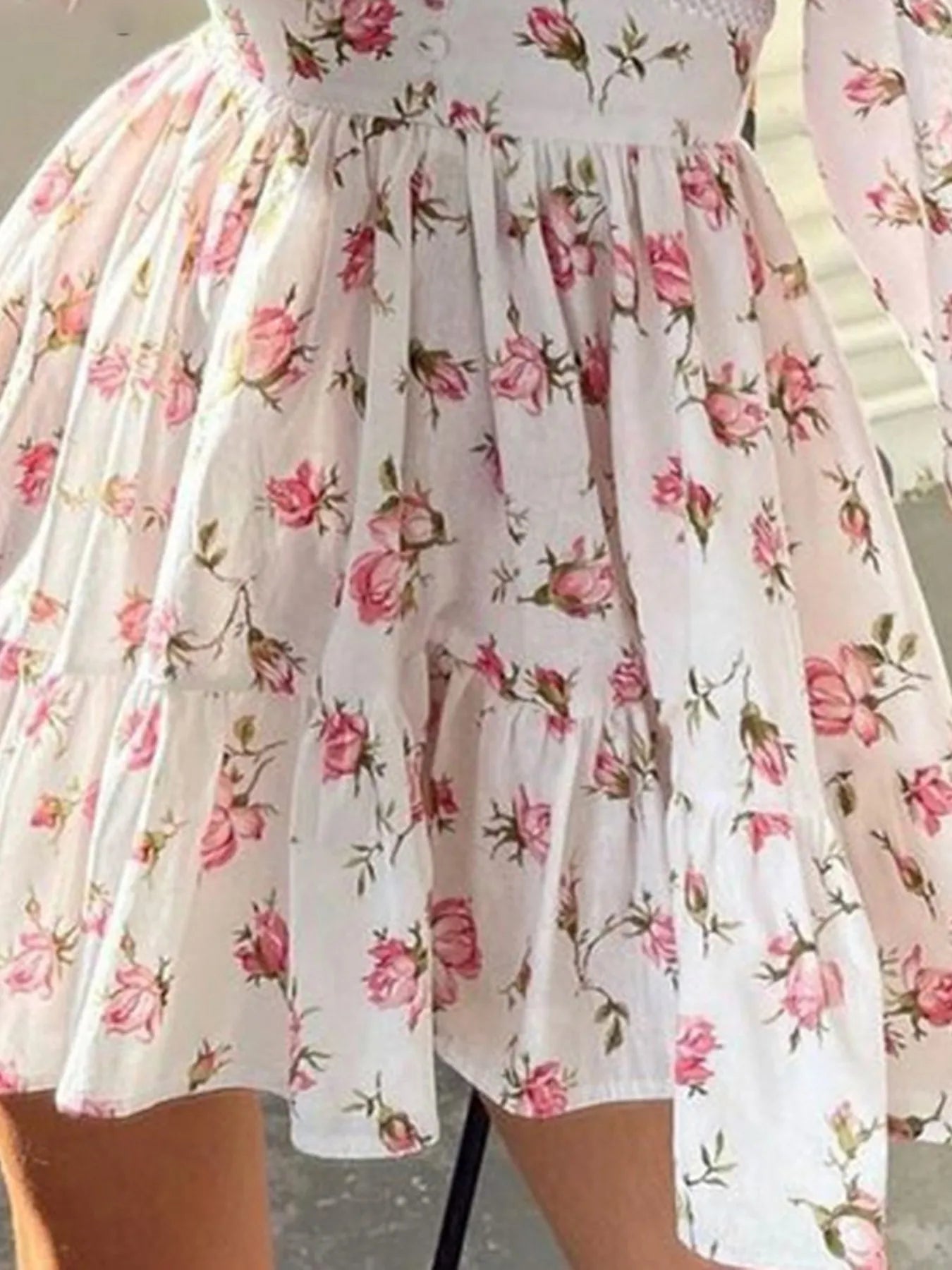 Plus size floral mini dress with V-neckline and long sleeves, featuring a flowy silhouette and romantic floral print — ideal for daytime or semi-formal wear
