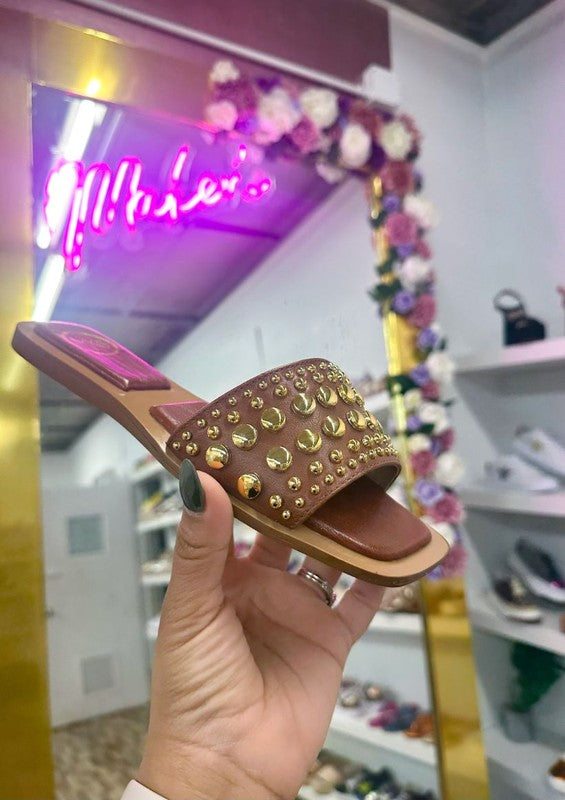 Slip-on sandals with pearl and stud embellished upper band, square toe silhouette, flat sole, and open-toe design