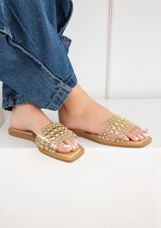 Slip-on sandals with pearl and stud embellished upper band, square toe silhouette, flat sole, and open-toe design