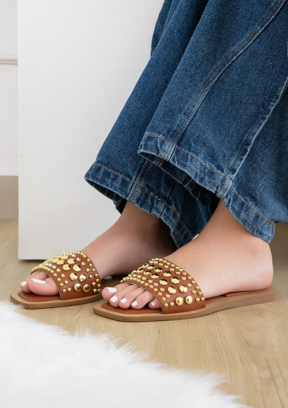 Slip-on sandals with pearl and stud embellished upper band, square toe silhouette, flat sole, and open-toe design