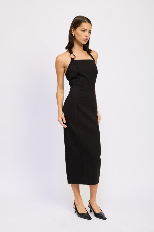 Woman models a chic halter neck midi dress in a black color, featuring an elegant design, posing sideways.