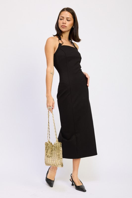 Woman models a chic halter neck midi dress in a black color, featuring an elegant design. full view