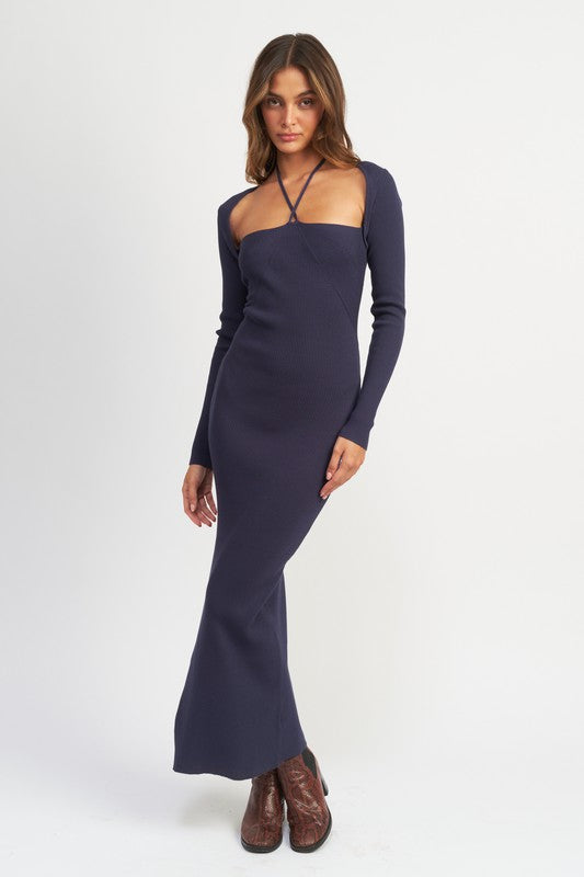 Woman wearing a long-sleeve navy dress on a white background