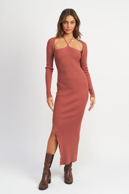 Woman wearing a long-sleeve, cut-out dress with a slit on a white background