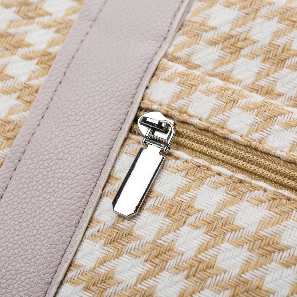 Beige and white houndstooth handbag with light gray handles and a structured, rounded shape. Soft and stylish—perfect for everyday fashion.