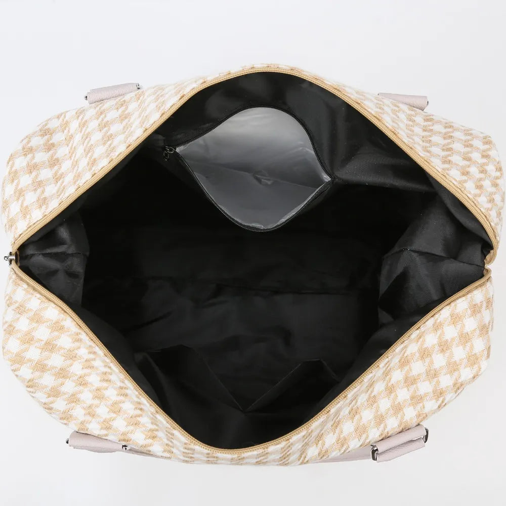 Open beige and white houndstooth handbag with light pink handles, showing a spacious black-lined interior with multiple pockets. Functional and chic—great for organized everyday use.