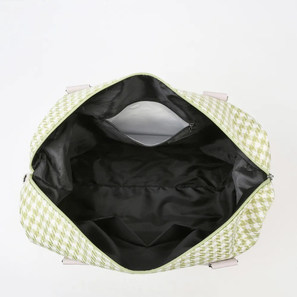 Open green and white houndstooth handbag with light pink handles, showing a spacious black-lined interior with multiple pockets. Functional and chic—great for organized everyday use.