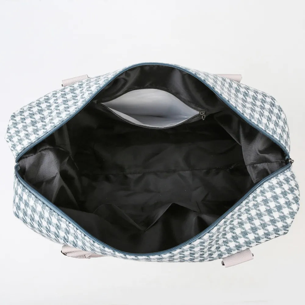 Open green and white houndstooth bag with a spacious black-lined interior and multiple organizing pockets. Stylish and practical—ideal for everyday use.