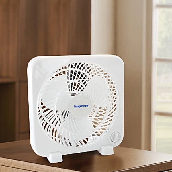 White square Impress electric fan with circular grille and control dial—designed for tabletop use and personal cooling.