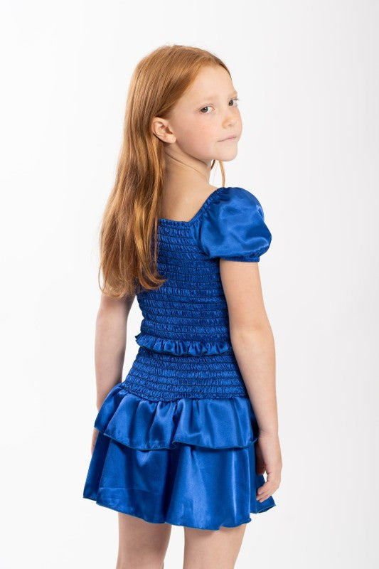 Young girl wearing a blue dress on a white background