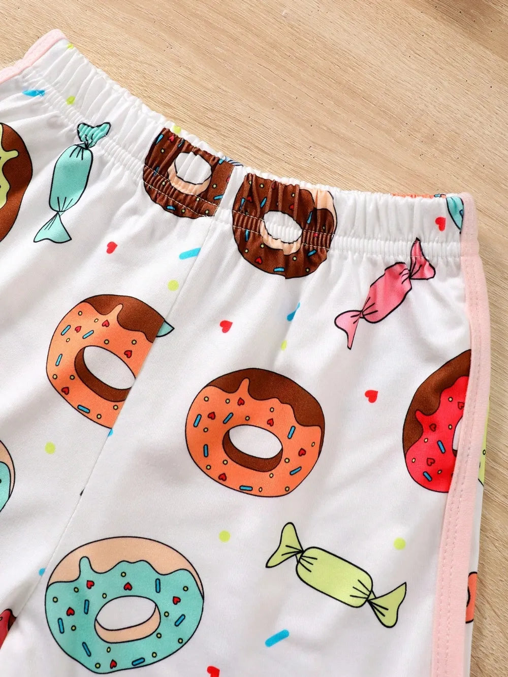 Children’s donut graphic round-neck top paired with matching pants in soft knit fabric