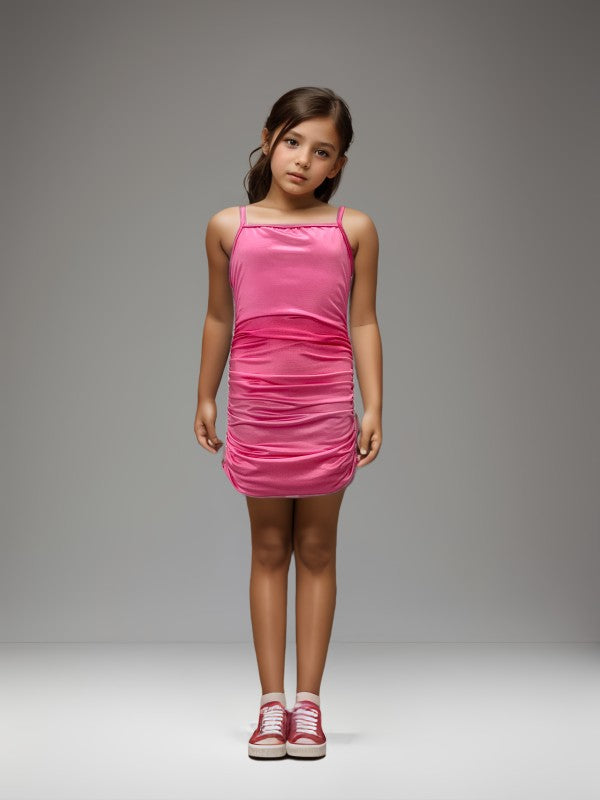 Young girl wearing a pink dress against a gray background