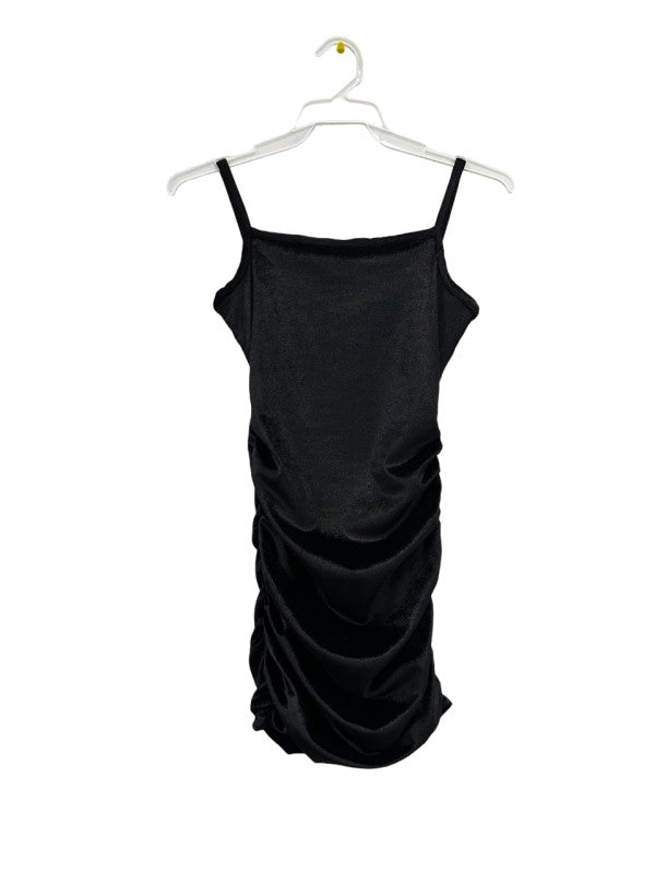 Black dress on a hanger against a white background