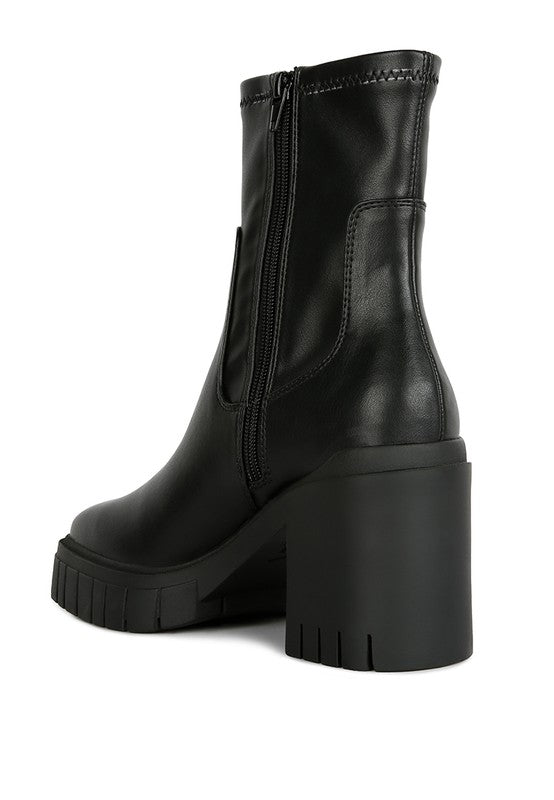 Black leather ankle boot with a chunky platform heel.