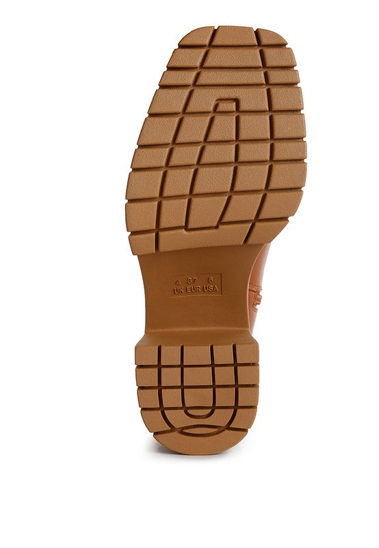 Brown leather ankle boot with a chunky platform heel.