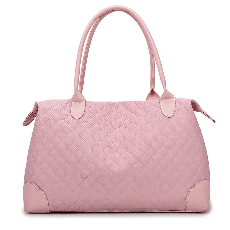 Light pink quilted handbag with diamond stitching, sturdy handles, and a zippered top. Elegant and structured—perfect for everyday or casual outings.