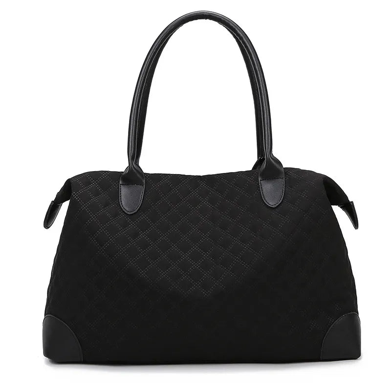 Black quilted handbag with diamond stitching, sturdy handles, and a zippered top. Elegant and structured—perfect for everyday or casual outings.