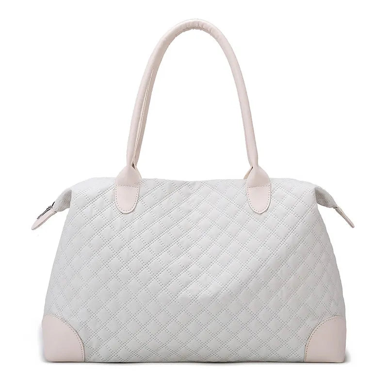 Light gray quilted handbag with diamond stitching, sturdy handles, and a zippered top. Elegant and structured—perfect for everyday or casual outings.