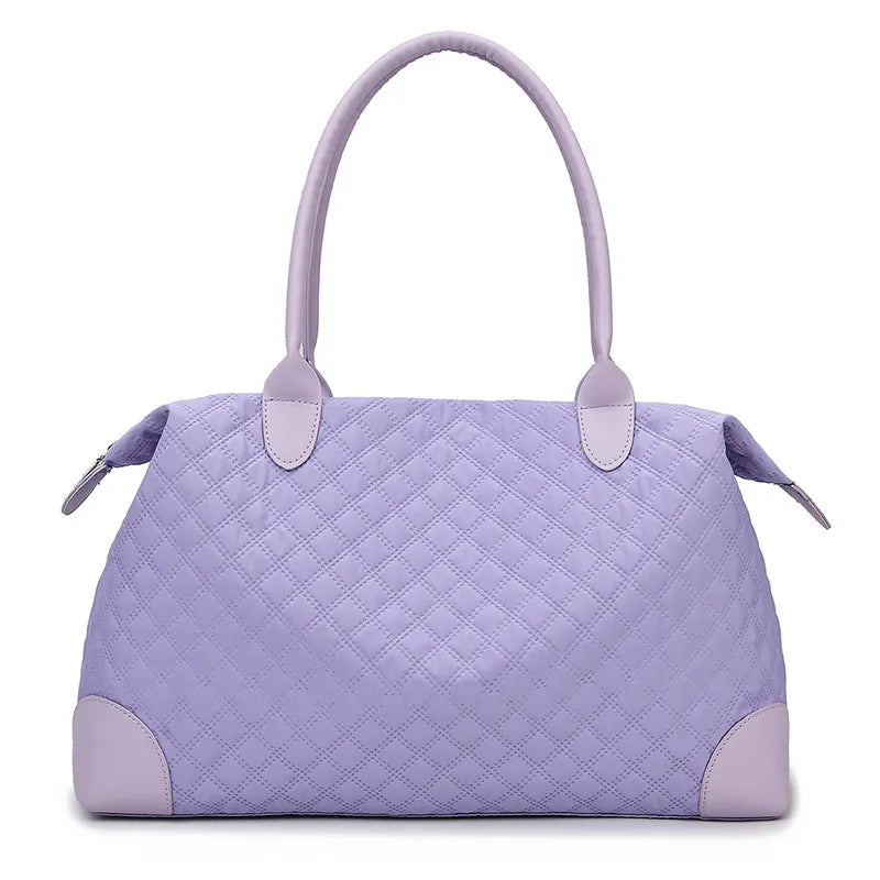 Lavender quilted handbag with diamond stitching, sturdy handles, and a zippered top. Elegant and structured—perfect for everyday or casual outings.