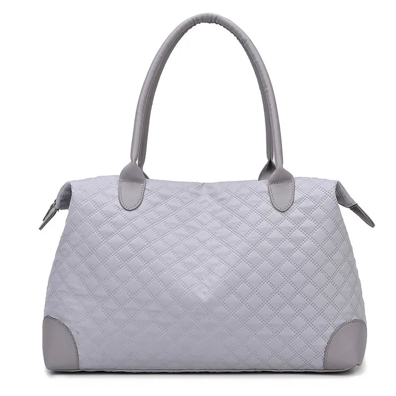 Light gray quilted handbag with diamond stitching, sturdy handles, and a zippered top. Elegant and structured—perfect for everyday or casual outings.
