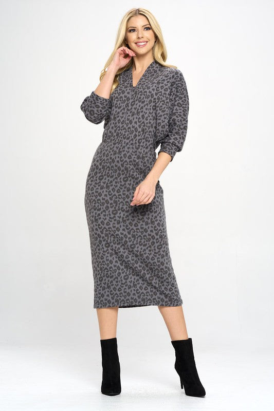 A woman models a Leopard Print Knit Dolman Sleeve Midi Dress, full front view.