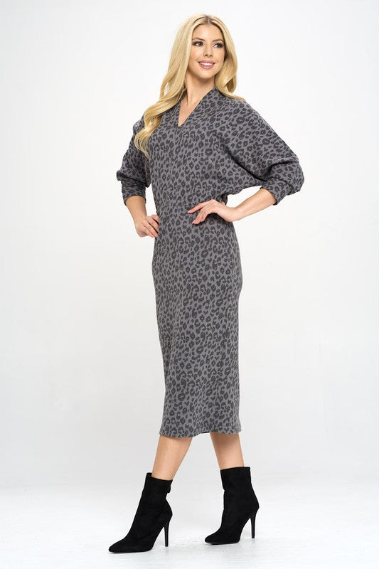 A woman wearing a Leopard Print Knit Dolman Sleeve Midi Dress, posing elegantly.