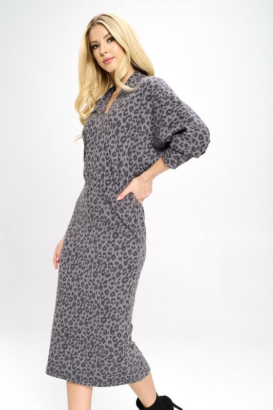 A woman poses in a Leopard Print Knit Dolman Sleeve Midi Dress