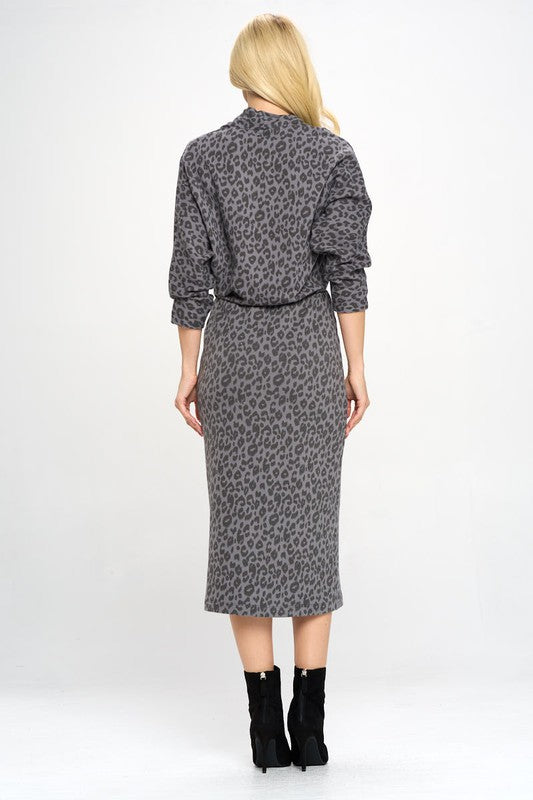 A woman in a Leopard Print Knit Dolman Sleeve Midi Dress, back view.