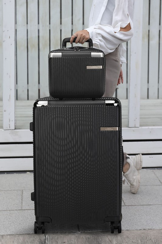two-piece hardshell luggage set stacked on a sidewalk, featuring a textured design and spinner wheels.