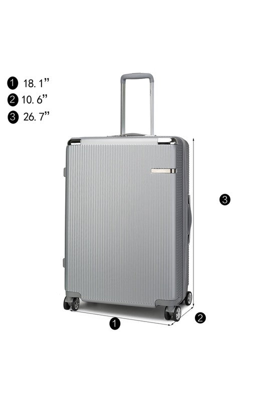 Silver hard-shell suitcase with four wheels and extended telescopic handle—measuring 18.1" wide, 10.6" deep, and 26.7" high. Features a textured surface and side handle.