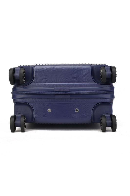 Dark blue hard-shell suitcase with vertical ribbed texture, extended telescopic handle, and four spinner wheels—standing upright on a wooden floor.