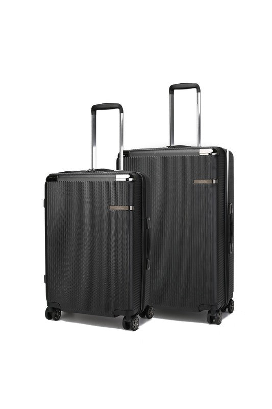 Two black hard-shell suitcases with vertical texture, extended telescopic handles, and spinner wheels—standing side by side, with the left one slightly smaller than the right.