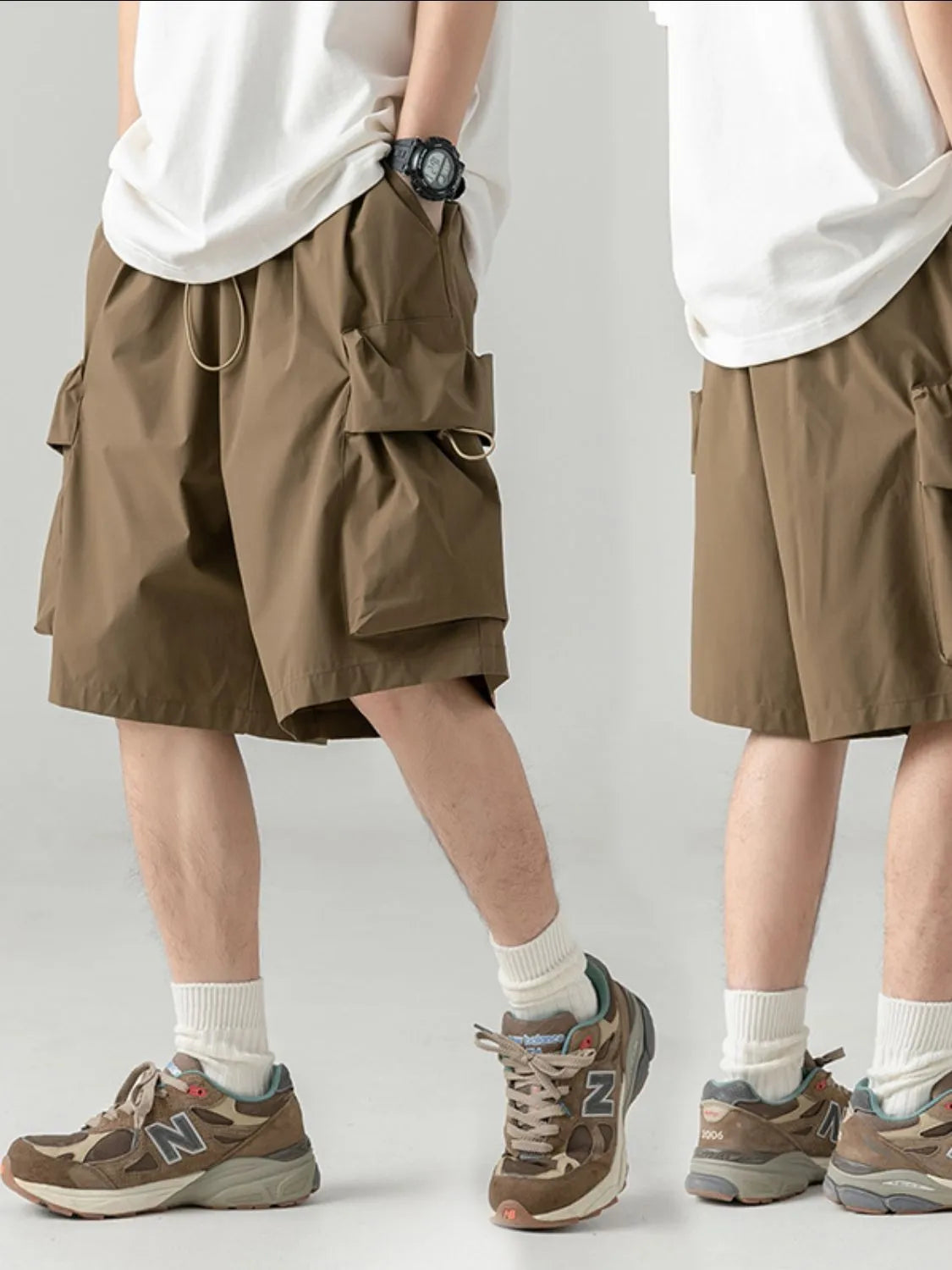 Two people wearing brown cargo shorts and brown sneakers on a plain background