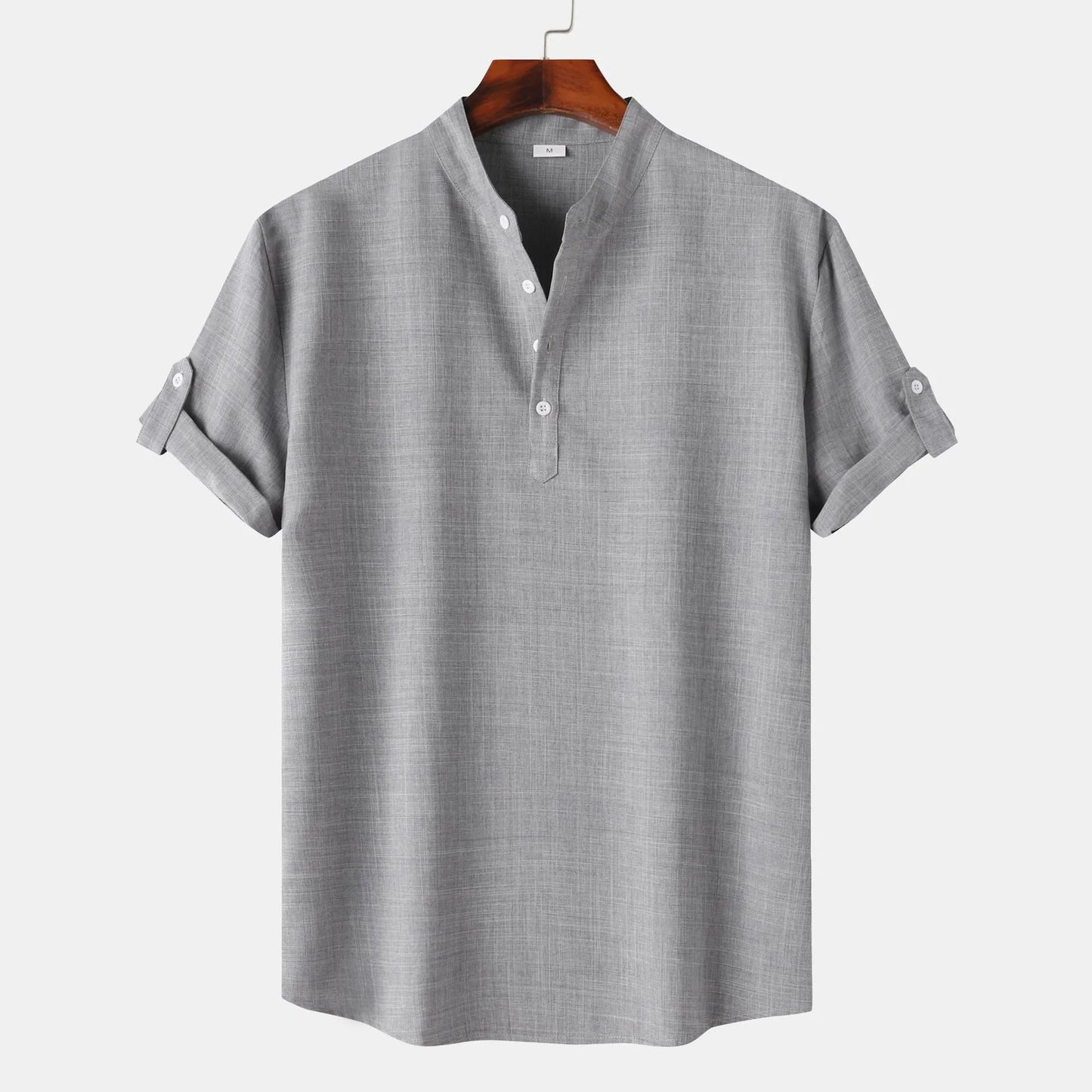 Gray short-sleeve shirt on a hanger against a white background
