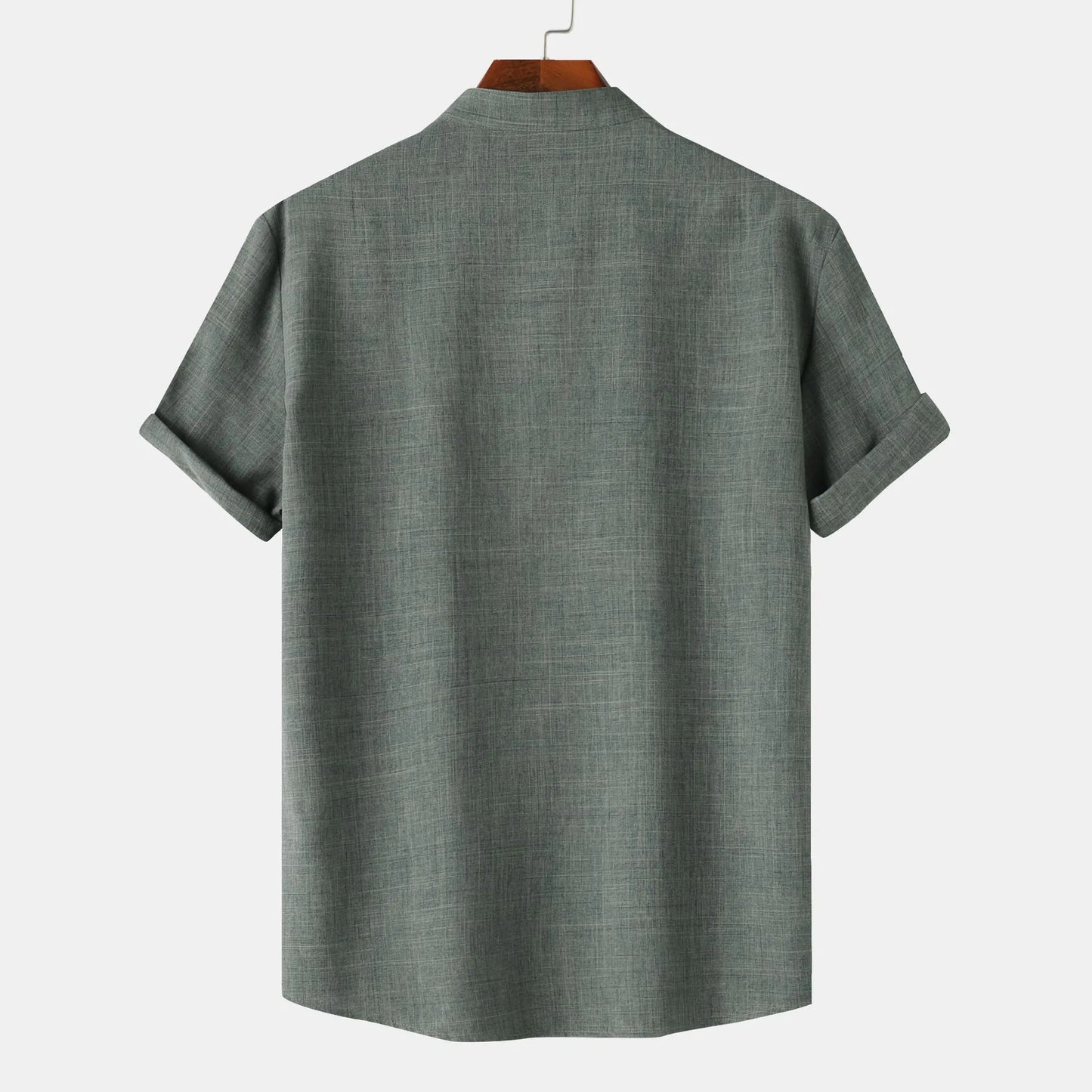 Green shirt on a hanger against a white background