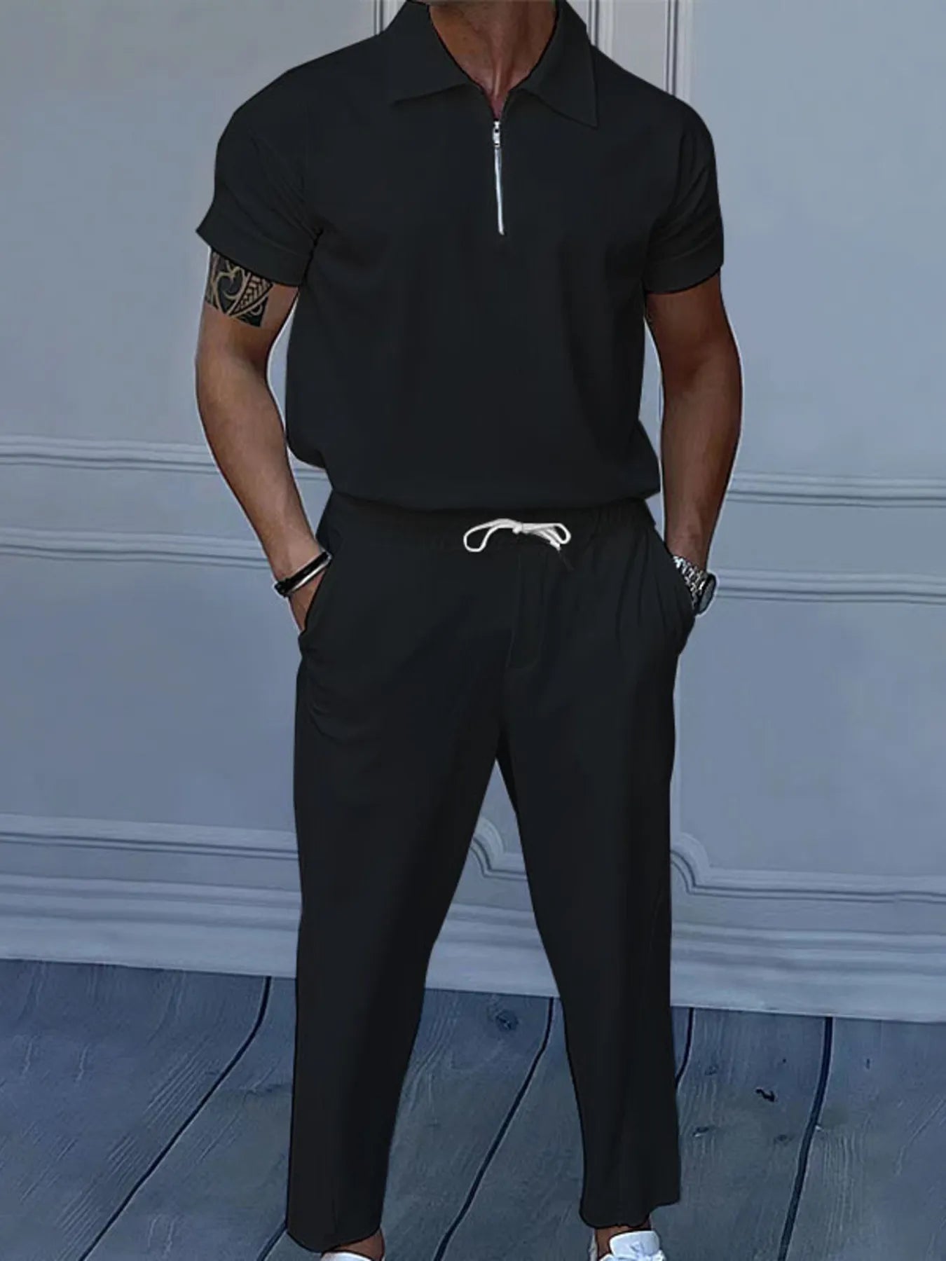 This is a plus-size men's two-piece set featuring a quarter-zip polo with short sleeves and matching pants, designed for comfortable, easy-wear versatility.
