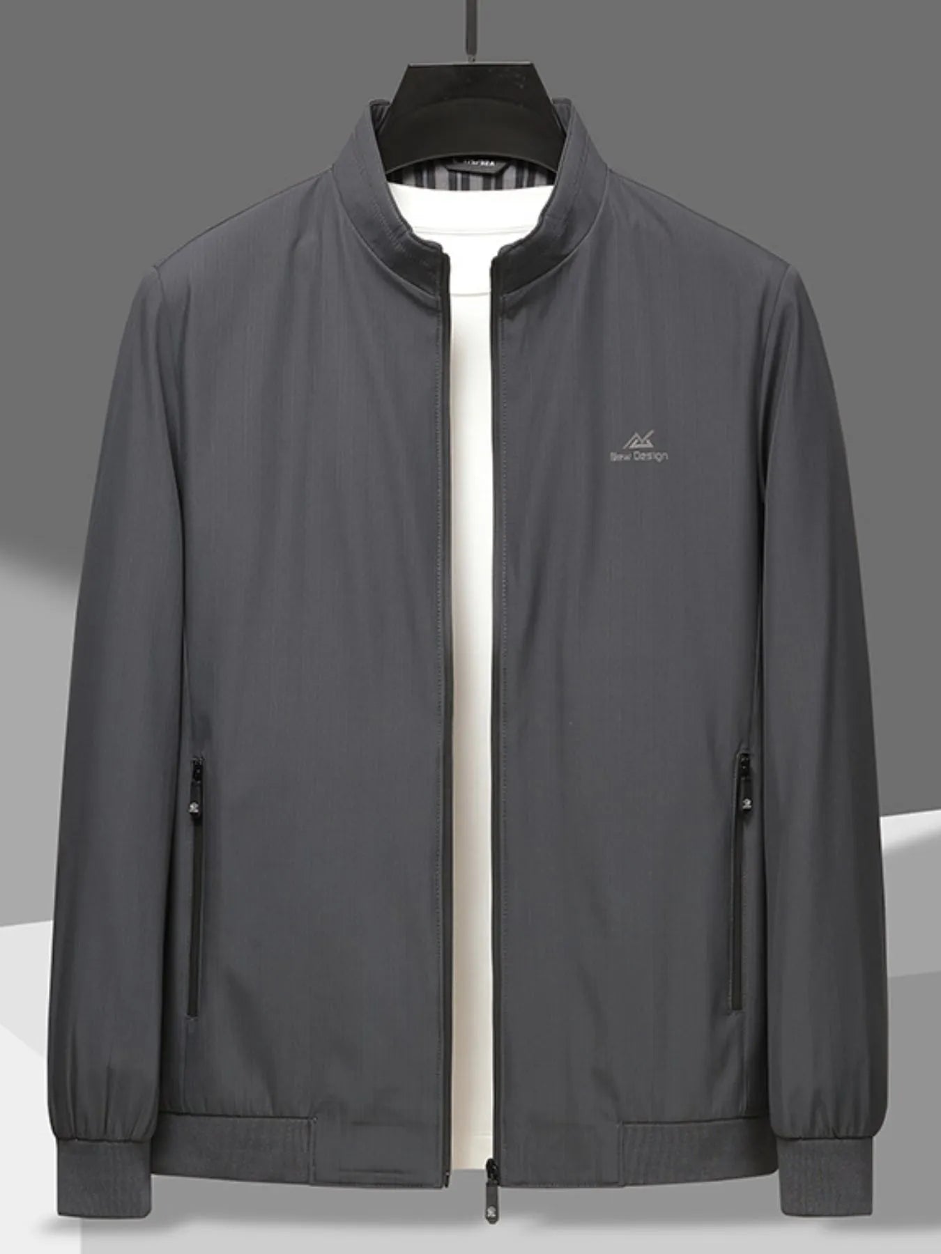 Men’s gray zip-up long sleeve jacket with front zipper pockets, hung over a white t-shirt