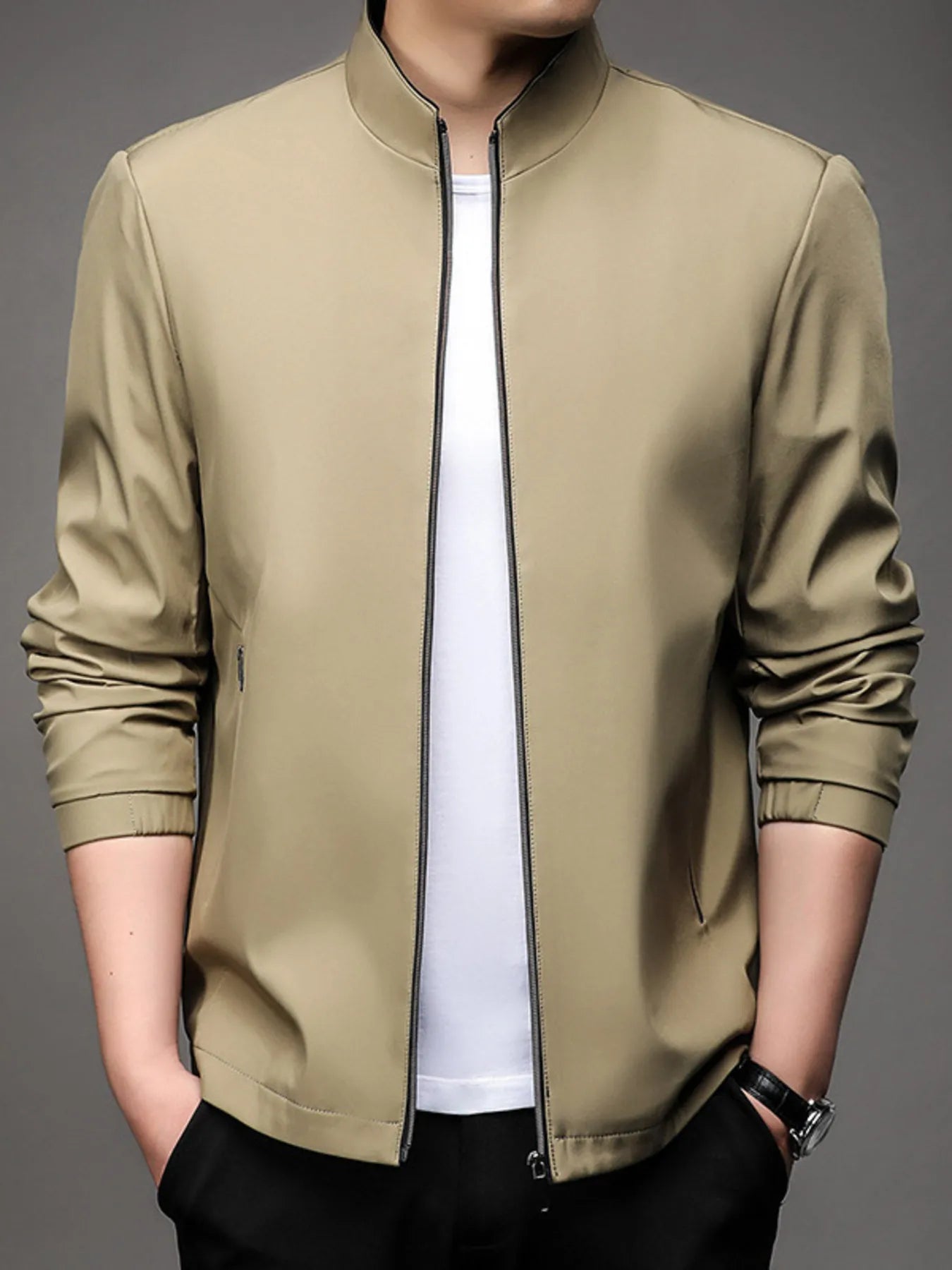 Men’s light brown zip up long sleeve jacket with side zipper pockets, worn over a white t-shirt