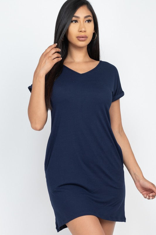 Woman wearing a navy blue dress against a white background