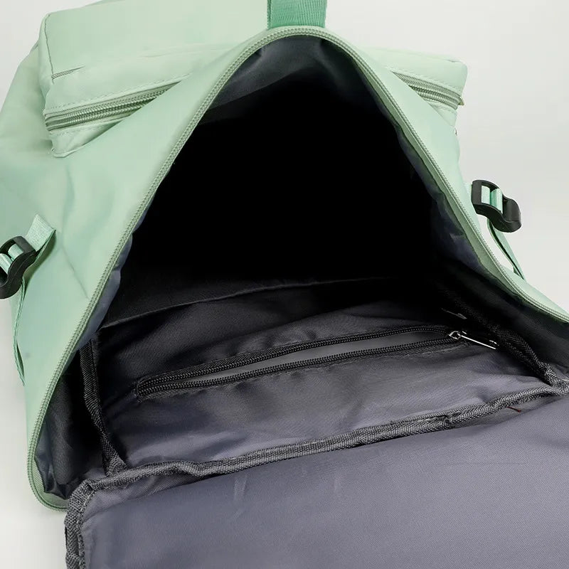 Open light green backpack with dark lining and a zippered interior pocket. Spacious and organized—ideal for everyday use or travel.
