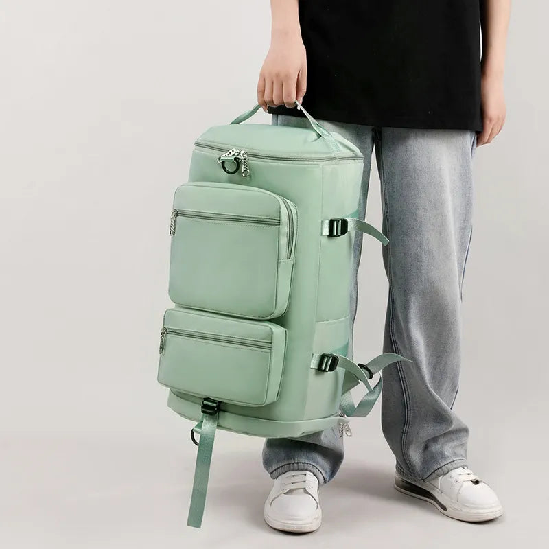 A man holding a large mint green backpack with multiple zippered compartments and side straps. Functional and stylish—great for travel or outdoor use.