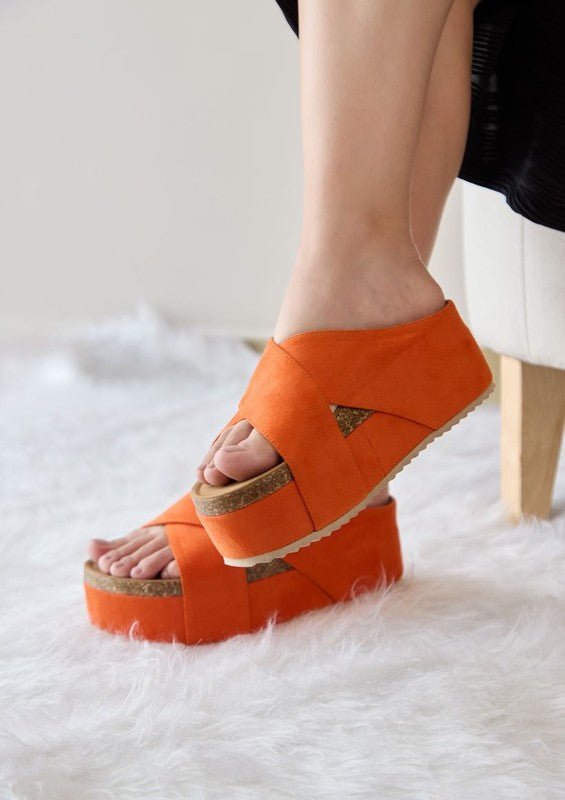 Flatform sandals featuring crossed textile bands, chunky platform sole with natural trim, open-toe cut, slip-on construction