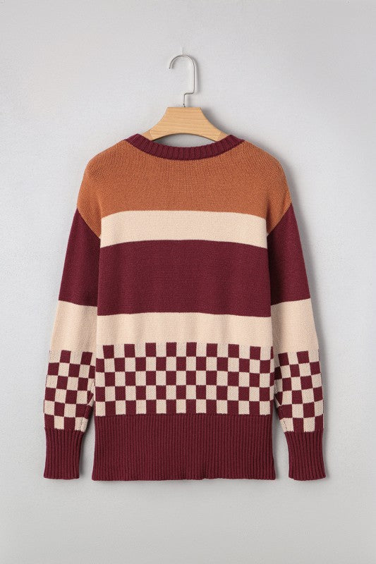 Checkered color block sweater featuring warm tones like rust, burgundy, and cream, with a classic crew neck and ribbed cuffs, front view.