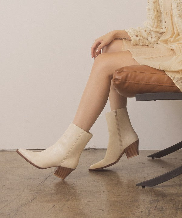 Leather ankle boots with square toe, stacked wooden block heel, side zipper closure, and slip-on style